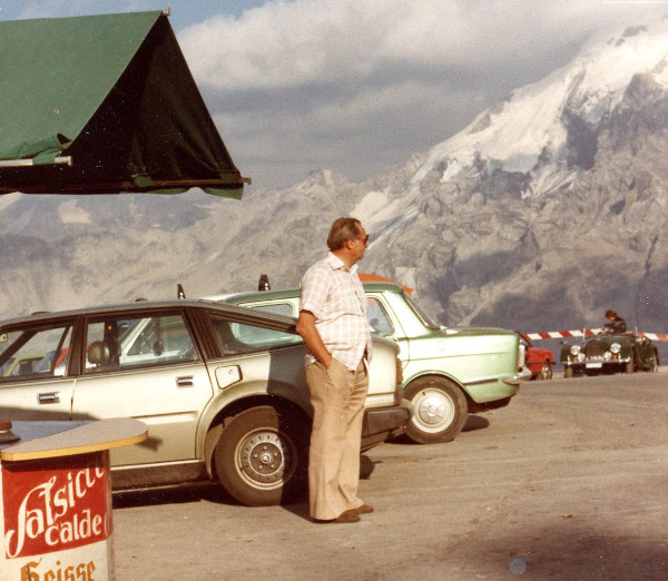 man standing outside alpine cafe